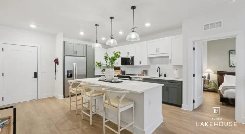 Modern apartment kitchen with island seating and pendant lights