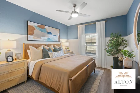 Bedroom with wicker bed, blue walls, and neutral decor