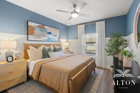 Bedroom with wicker bed, blue walls, and neutral decor
